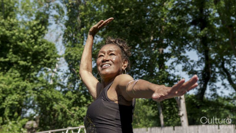 Senior woman doing yoga outdoors