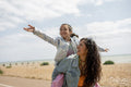 Mother giving daughter piggyback ride