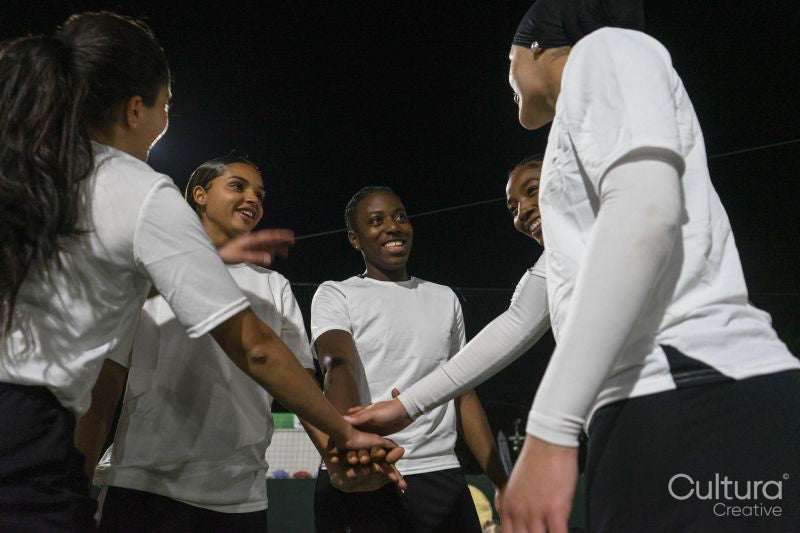 Female soccer players teaming up