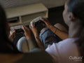 Female friends playing video games in gaming club