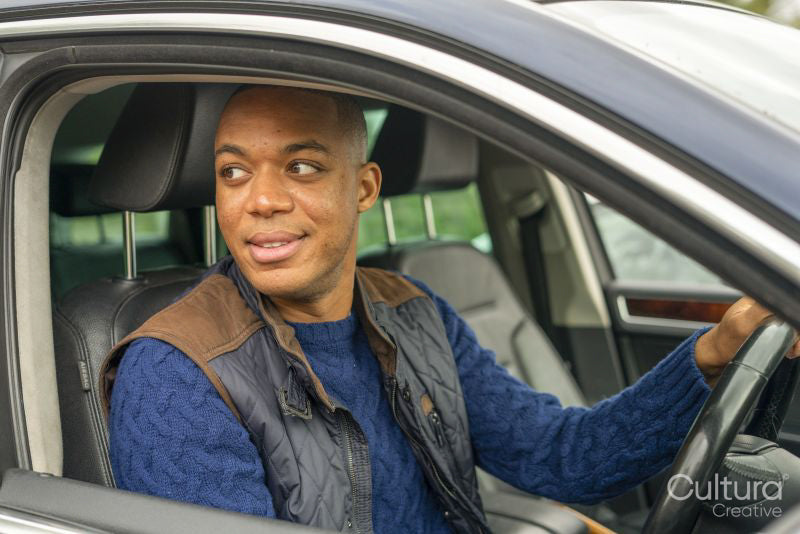 Man sitting in car and looking away
