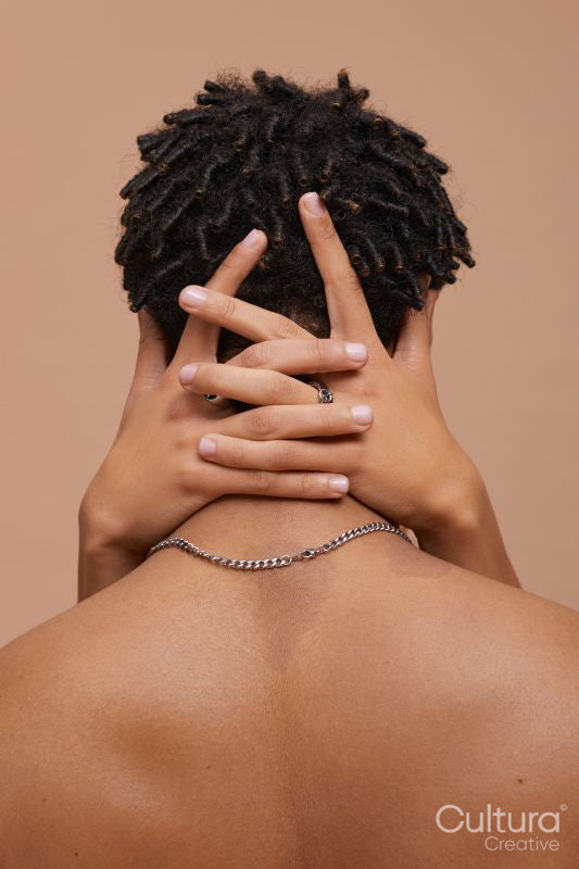 Studio rear shot of man embraced by partner