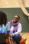 Teenage girl in wheelchair talking to grandmother