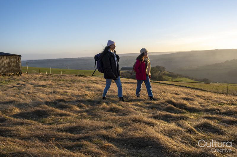 Female hikers walking in rural landscape