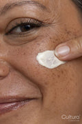 Close-up of woman applying face cream