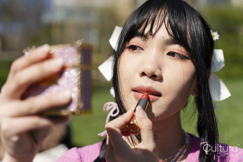 Young woman applying lip product