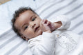 Portrait of baby girl with curly hair and brown eyes