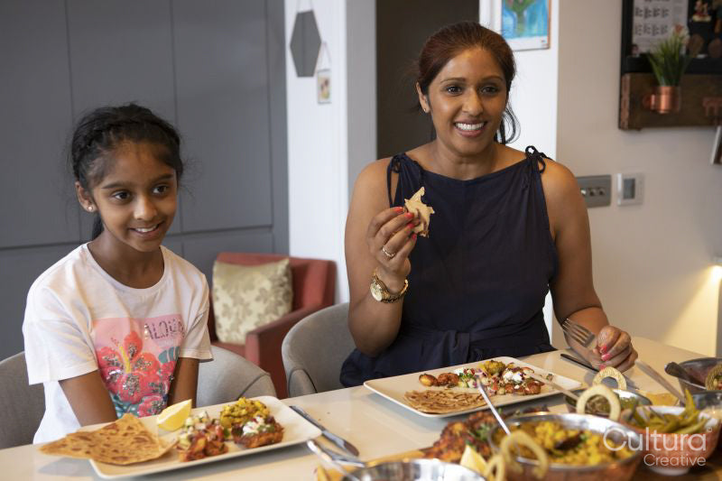 Mother and daughter enjoying dinner at home
