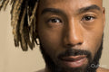 Studio portrait of young man with dreadlocks