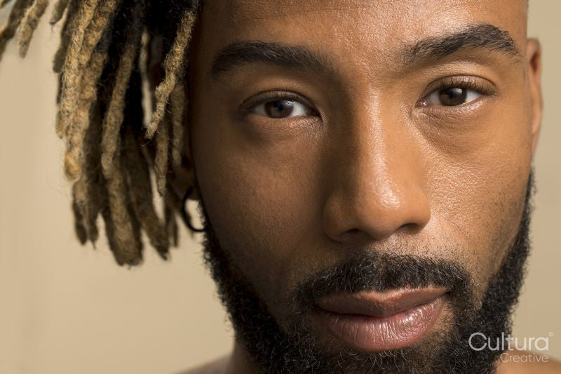 Studio portrait of young man with dreadlocks