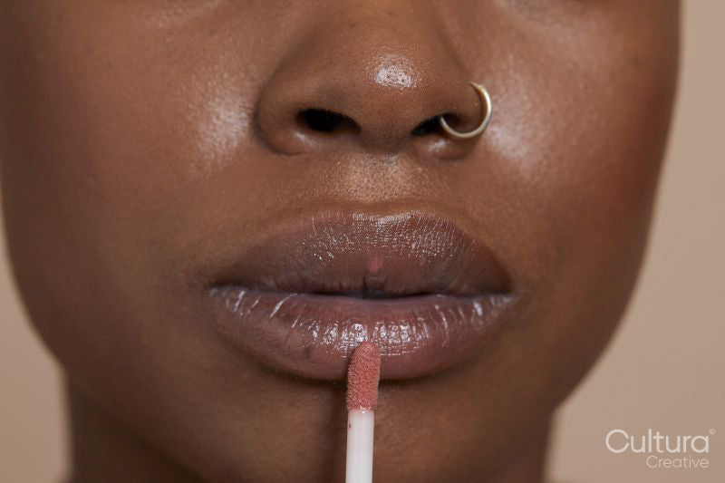 Close-up of woman applying lip gloss