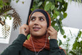 Portrait of smiling woman with earbuds