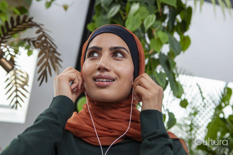 Portrait of smiling woman with earbuds