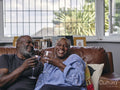 Couple sitting on sofa and drinking wine