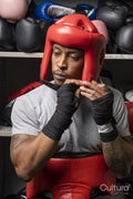 Mature man putting on head protector for boxing match