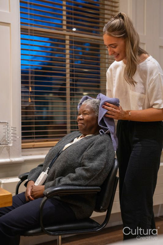 Senior woman getting hair dried in hair salon