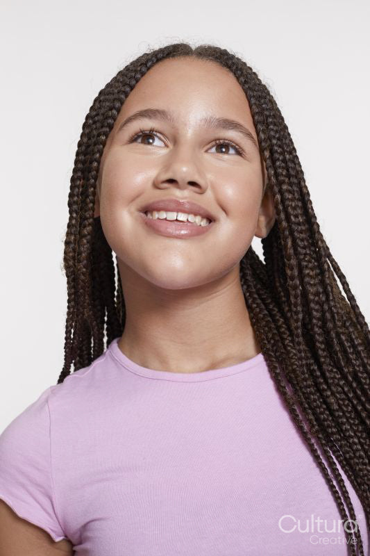 Studio portrait of smiling girl with braided hair