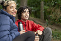 Mother and son relaxing in forest