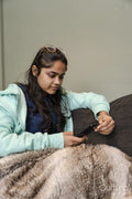 Young woman sitting on sofa and using phone