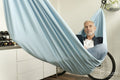 Smiling mature man using digital tablet in hammock