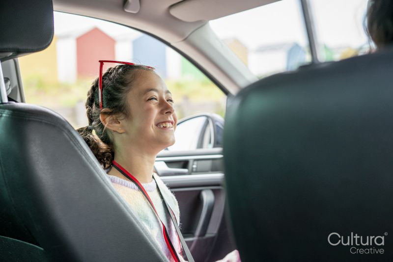 Smiling girl sitting in car