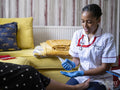 Nurse taking care of woman''s foot