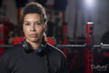 Portrait of woman with headphones in gym