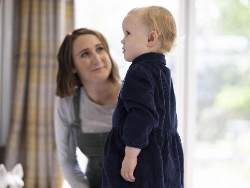 Mother looking at daughter at home