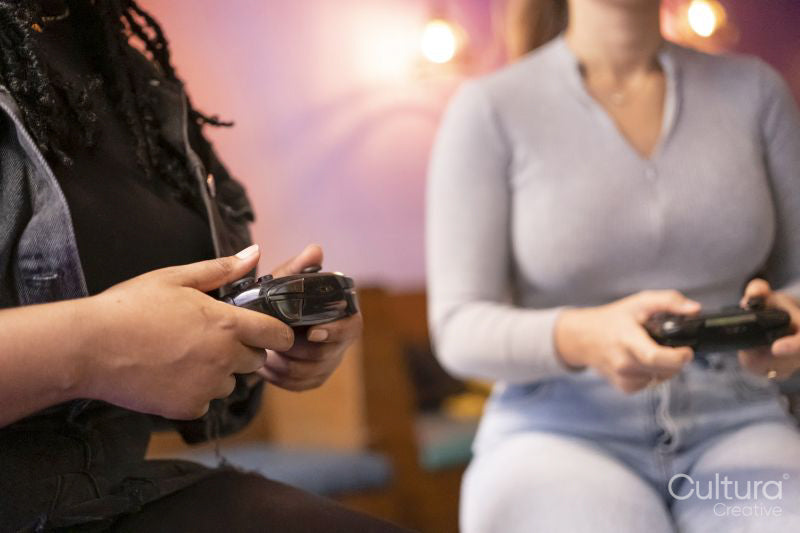 Close-up of female friends playing in video games at pub
