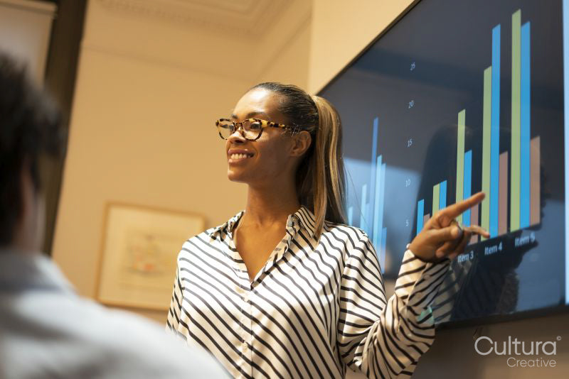 Businesswoman showing graphs during presentation