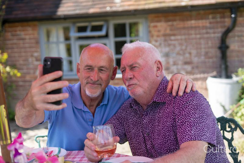 Senior male couple taking selfie