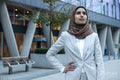 Portrait of businesswoman in hijab standing in city
