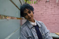 Portrait of young woman with blue hair