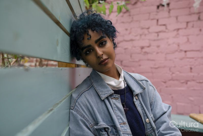Portrait of young woman with blue hair