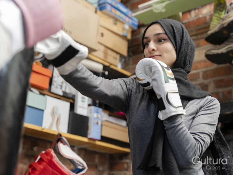 Woman punching boxing bag