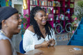 Young women laughing during card game