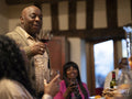 Family raising toast with red wine at Thanksgiving dinner