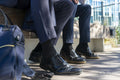 Feet of two businessmen sitting outdoors