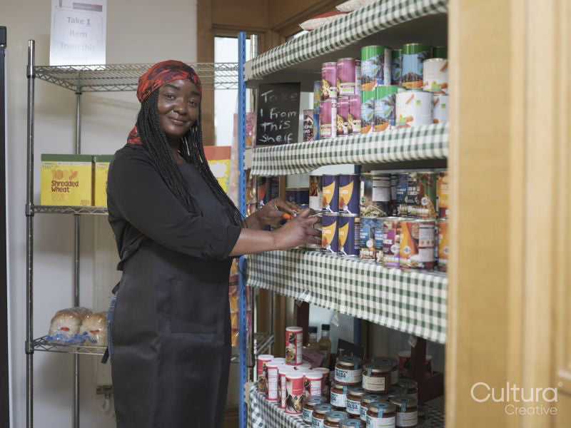 Portrait of female volunteer working in community food center