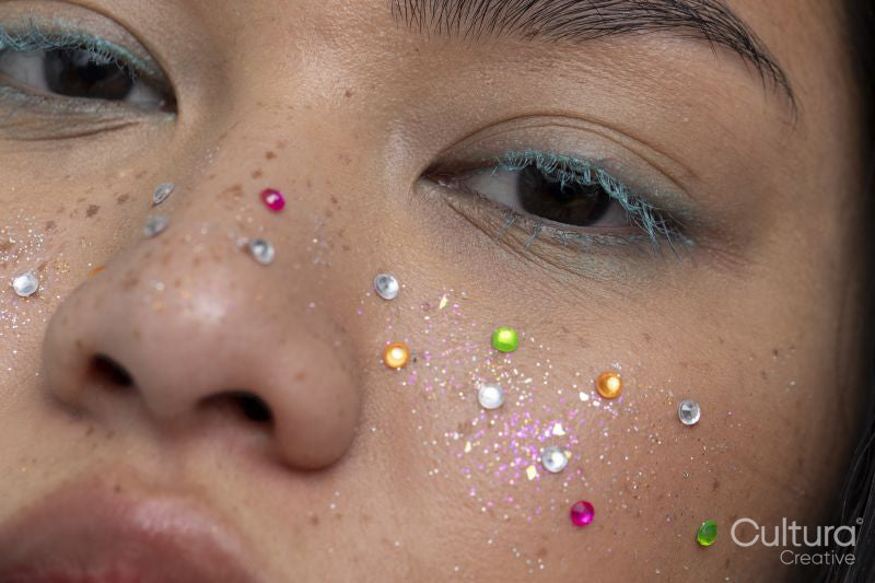 Close up of woman with colorful shiny freckles