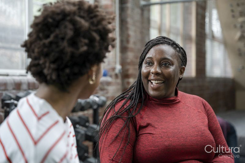 Mother with daughter talking in gym before training