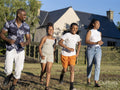 Family with children running in countryside