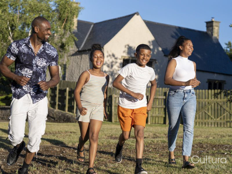 Family with children running in countryside