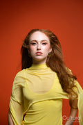 Woman in a yellow dress with windswept hair