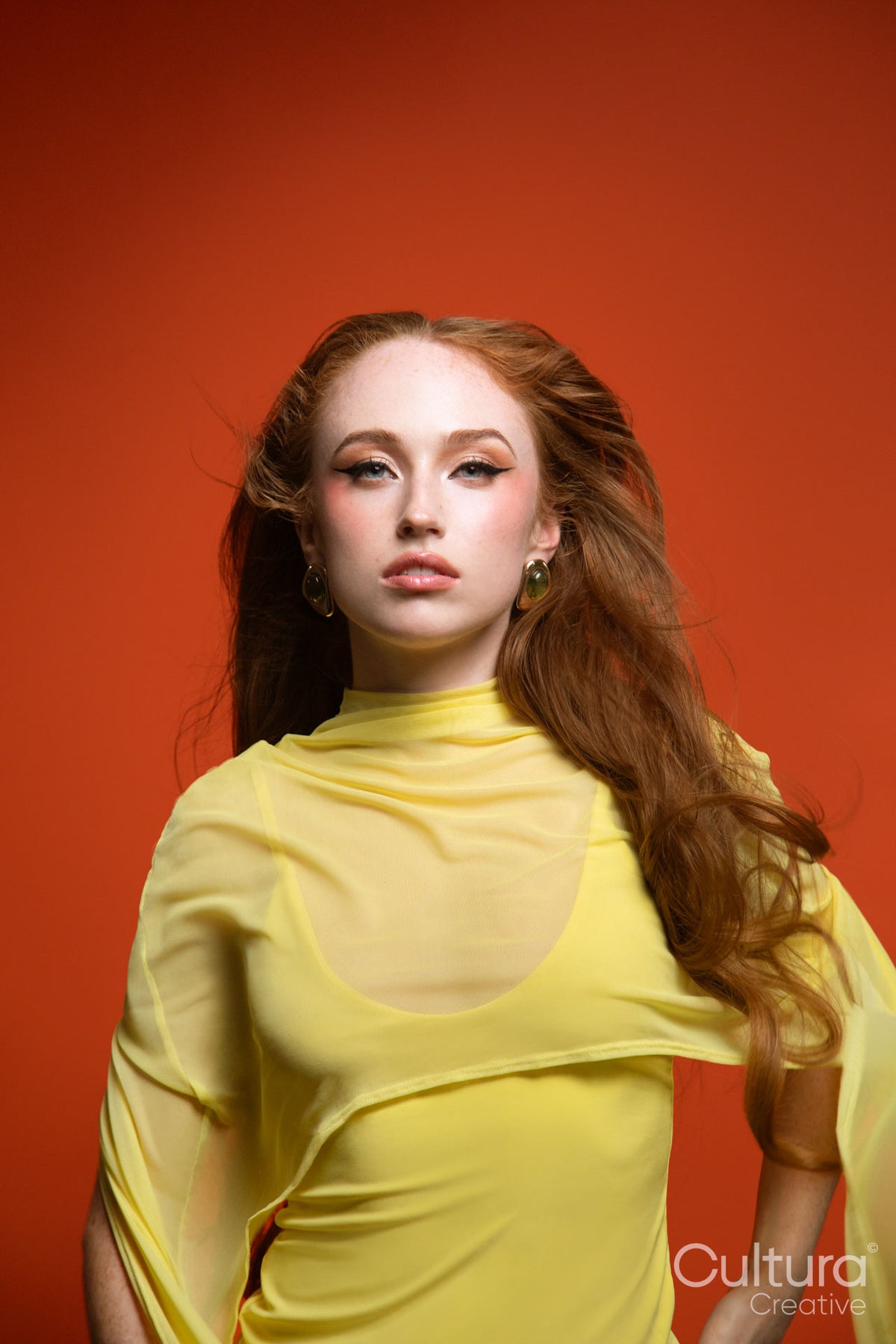 Woman in a yellow dress with windswept hair