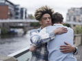 Young men hugging