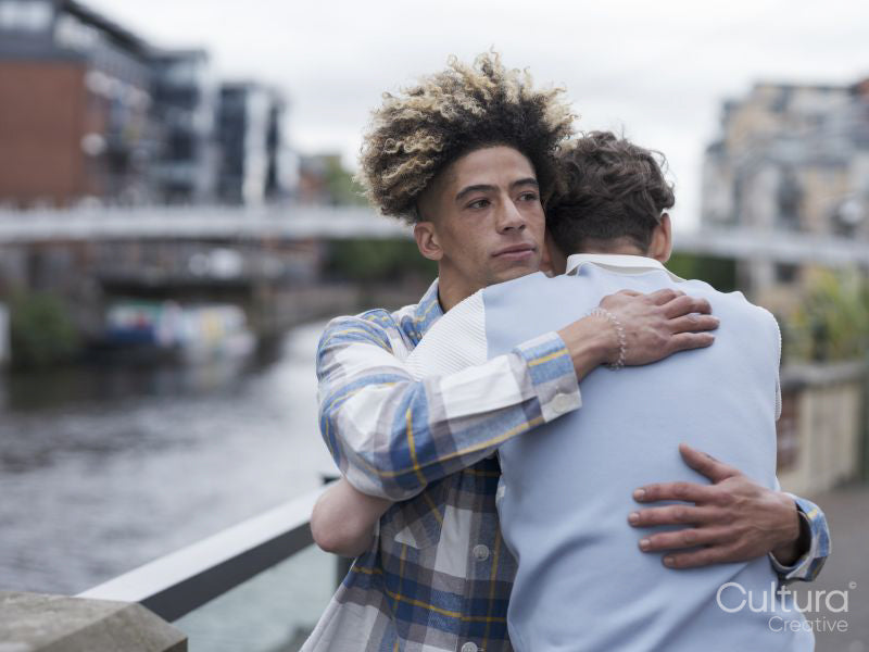 Young men hugging