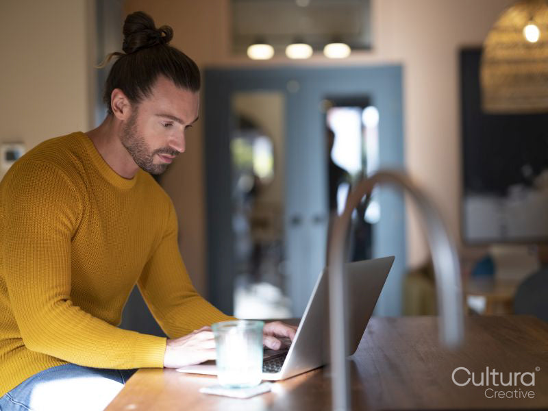 Handsome man using laptop at home