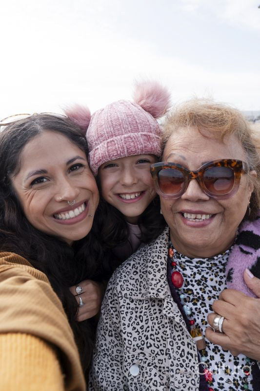 Grandmother, mother and daughter taking selfie