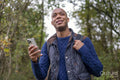 Man holding smart phone during nature walk in autumn